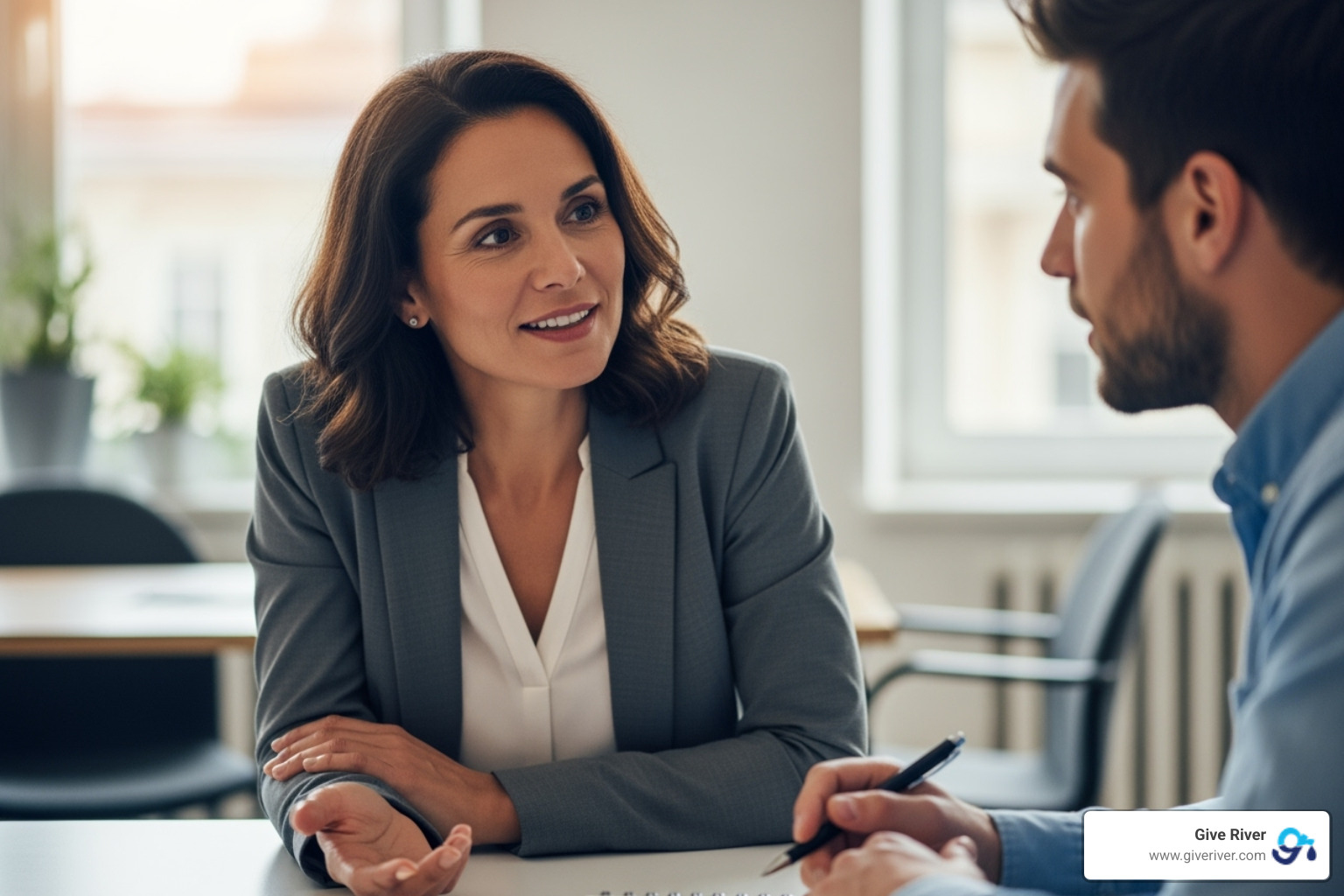 A leader actively and empathetically listening to a team member in a one-on-one setting, showing genuine connection - mindfulness in workplace