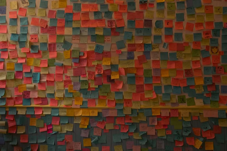 colorful wall with sticky notes containing peer recognition messages - peer to peer recognition activities
