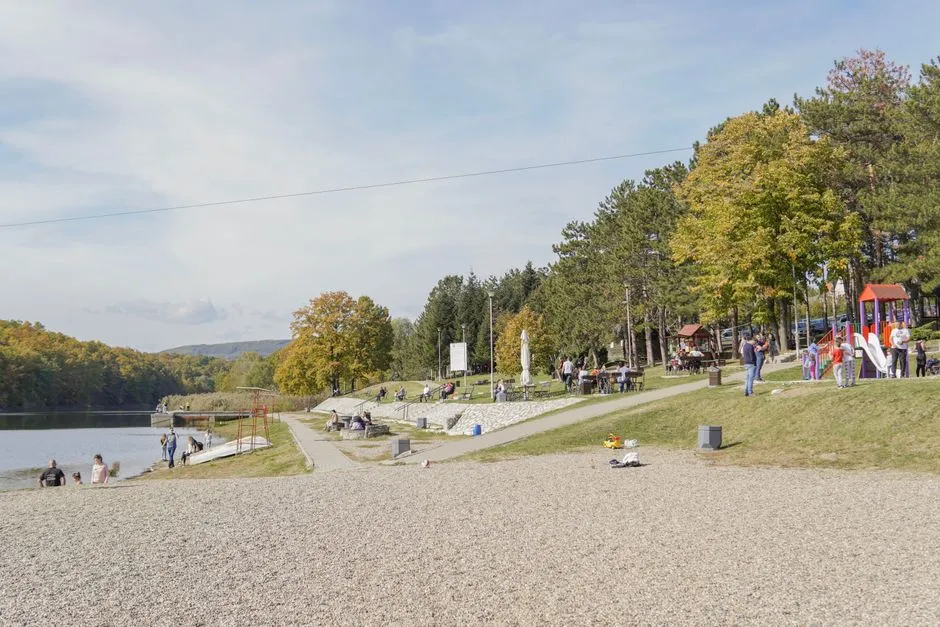 a vibrant public park with benches, walking paths, and a playground - building a better community
