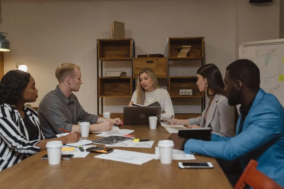 A leadership team modeling new collaborative behaviors during a strategy session - corporate culture transformation