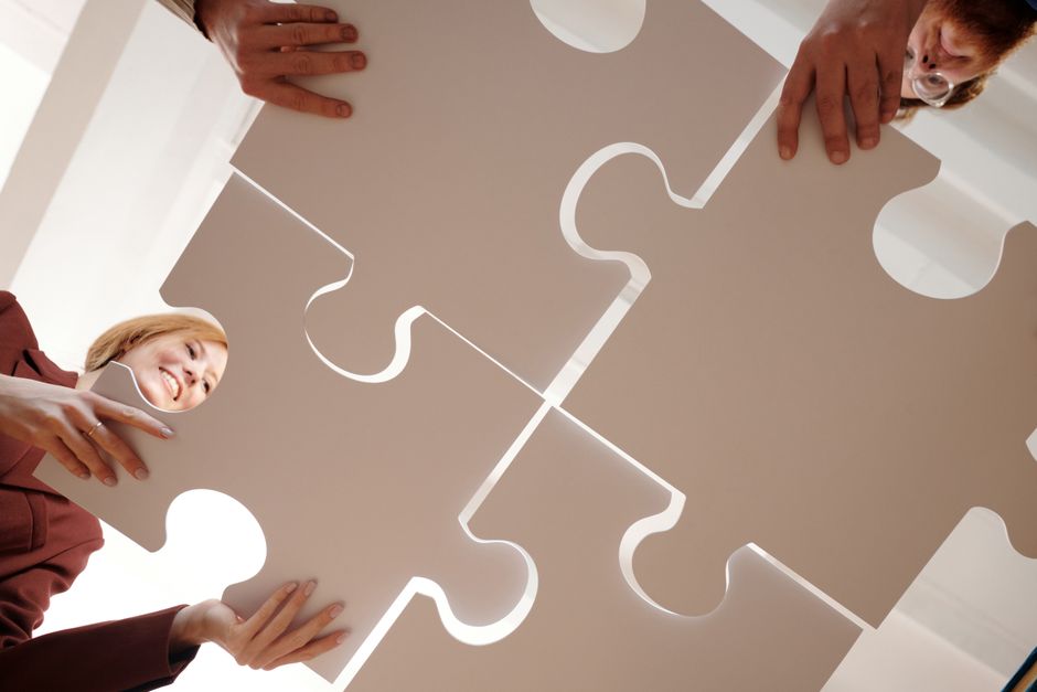 image of a team working on a puzzle during a relay - relay race ideas for team building