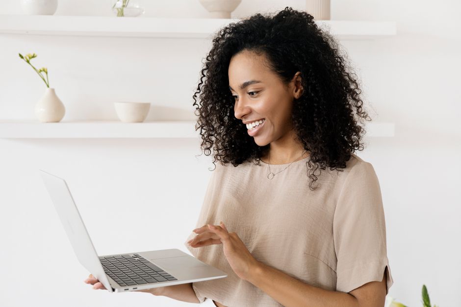 person smiling at laptop - virtual ice breakers