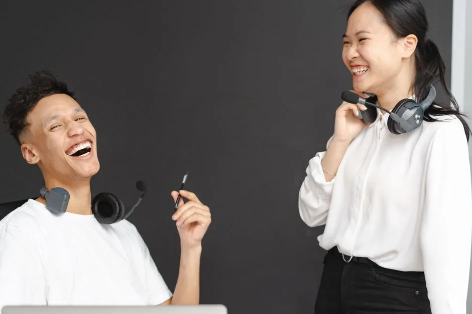 A remote team smiling and laughing during a grid-view video conference call