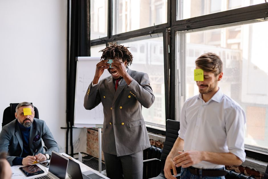 employees participating in an office scavenger hunt and laughing