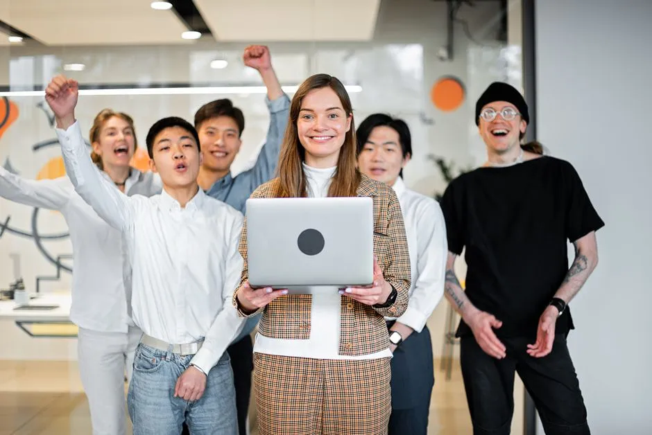 A diverse team celebrating a collaborative win in a modern office