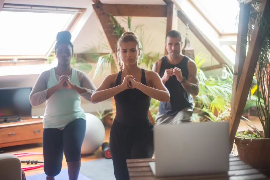 Image of a team participating in a virtual yoga session or a step challenge leaderboard - corporate wellness tools