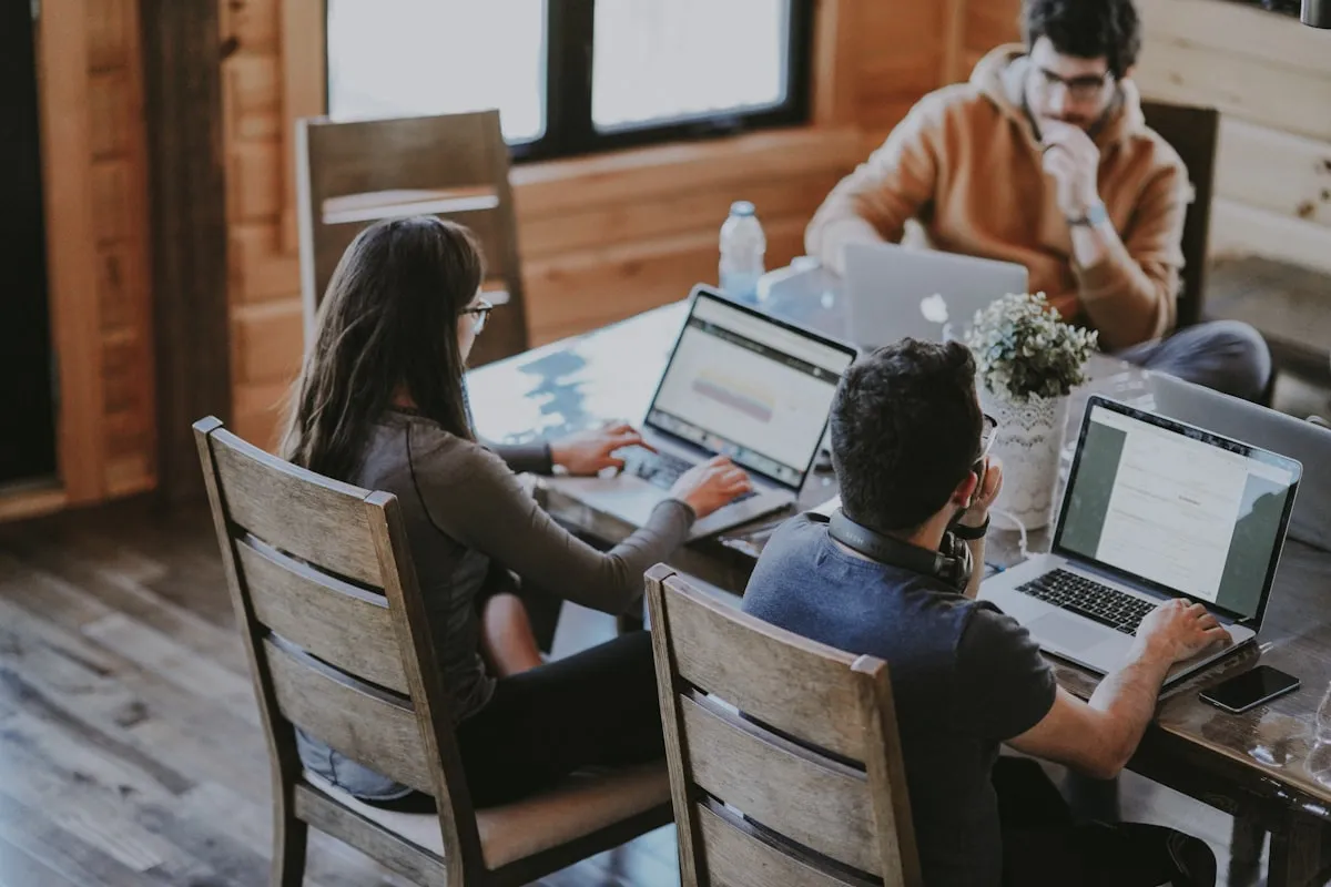 Diverse team collaborating in a modern office setting, showing people of different backgrounds working together on a learning project