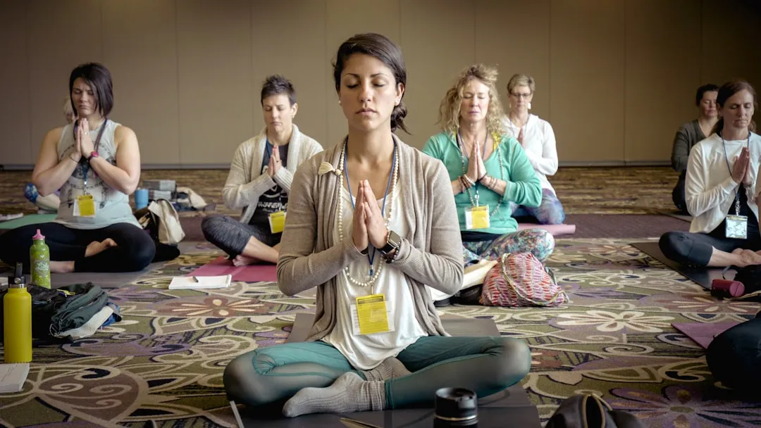 employees doing yoga together - team building activities