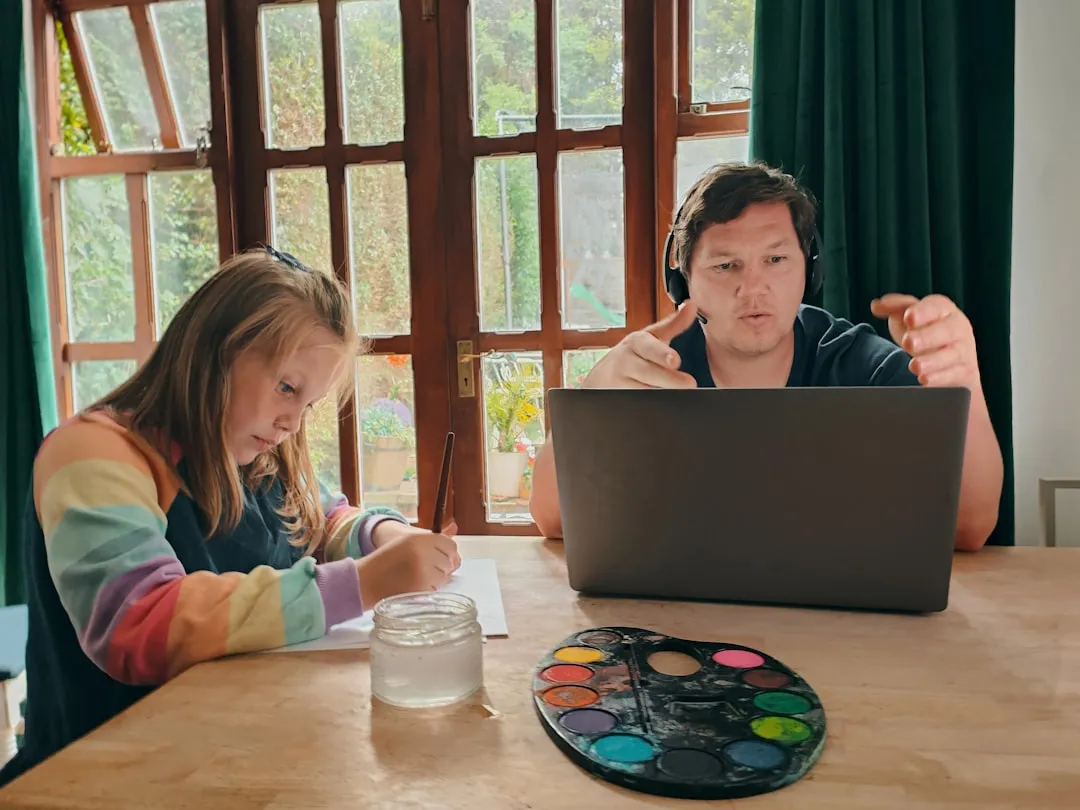 parent and teen looking at computer screen - online volunteer opportunities for minors