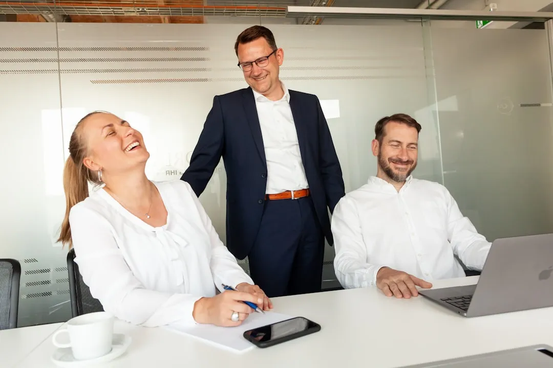 Team members laughing and high-fiving after completing a challenge - indoor team bonding exercises
