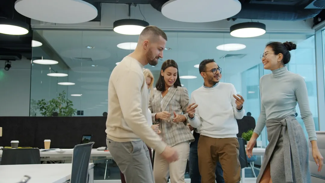 A diverse team celebrating a colleague winning an award - employee of the year award