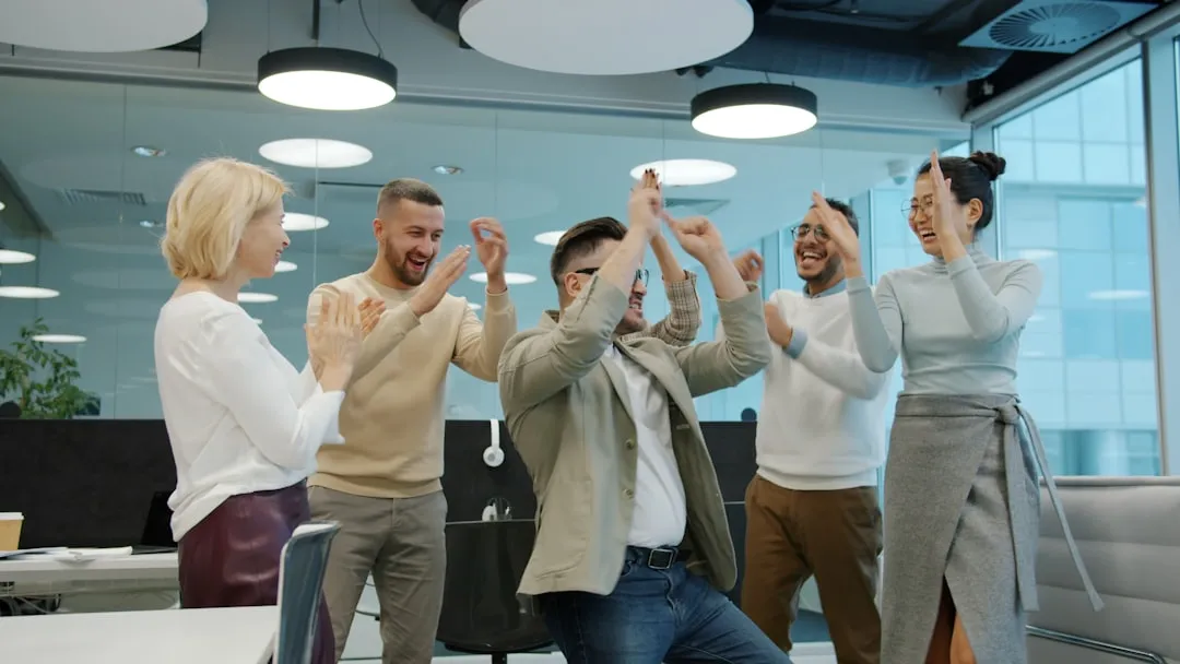 Team celebrating recognition and connection - workplace communication tools